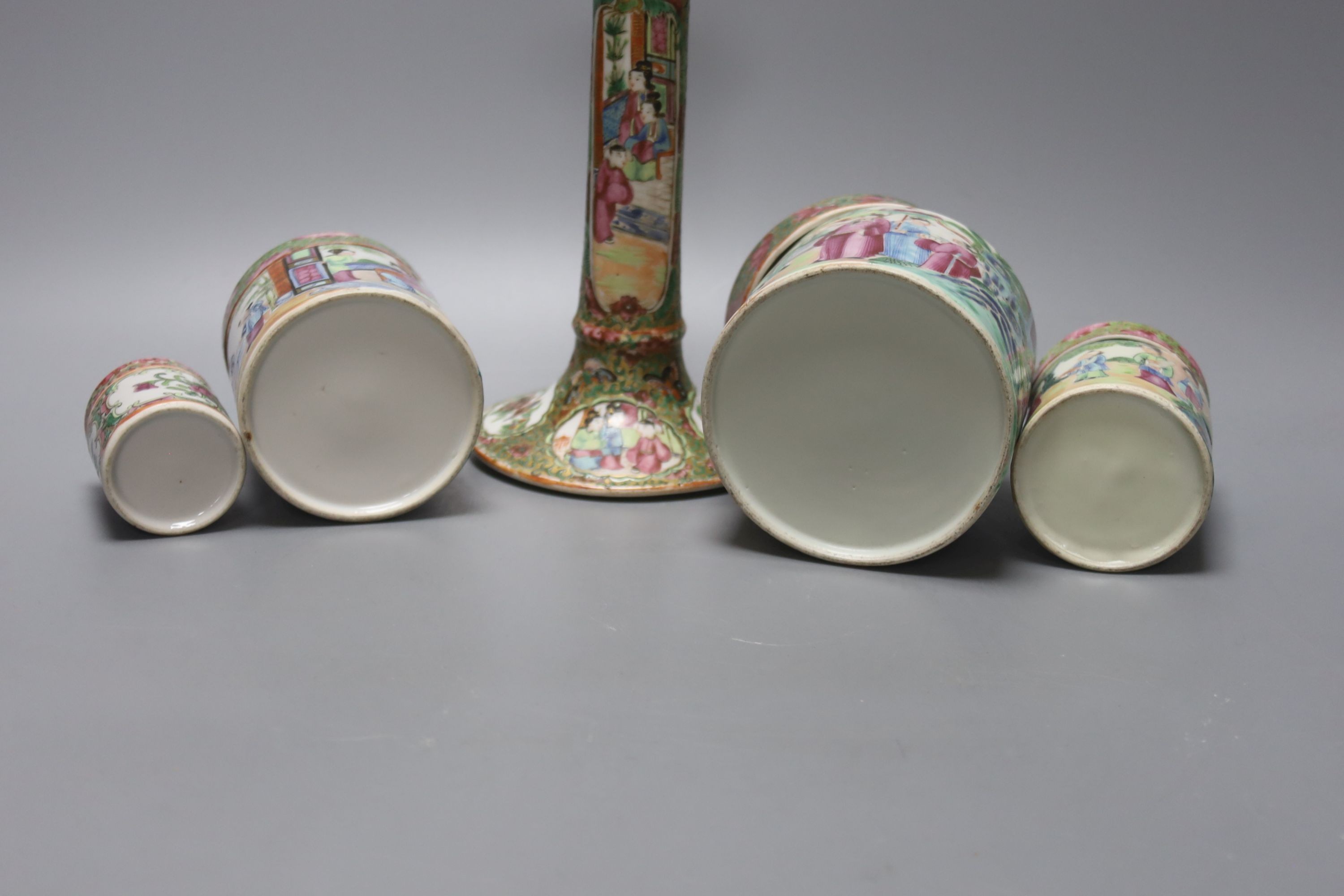 A Chinese Canton famille rose nest of boxes and covers, a similar candlestick and a tray 23cm